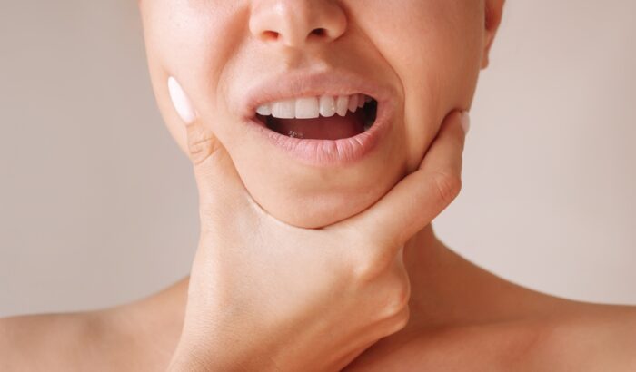 Cropped,Shot,Of,A,Young,Woman,Suffering,From,Jaw,Pain